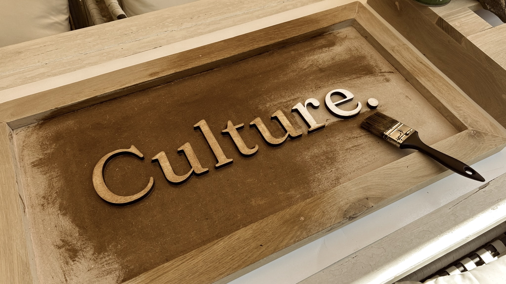 Culture. Painting a wooden cut of the logo of this great company.